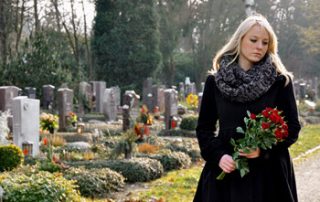 Women at grave wondering what to do because of no life insurance