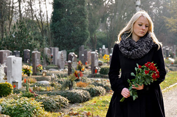 Women at grave wondering what to do because of no life insurance