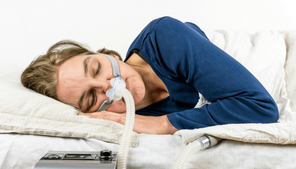 Women sleeping with a CPAP machine 