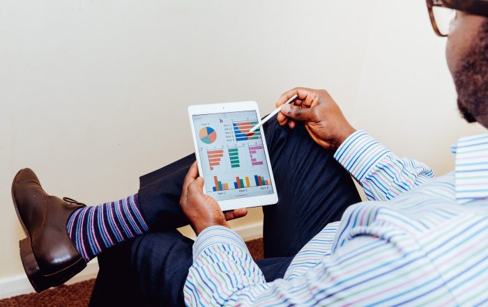 Man looking at tablet with life insurance charts on screen